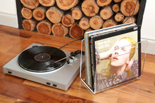 love it own it vinyl record holder containing vinyl lps next to a record player